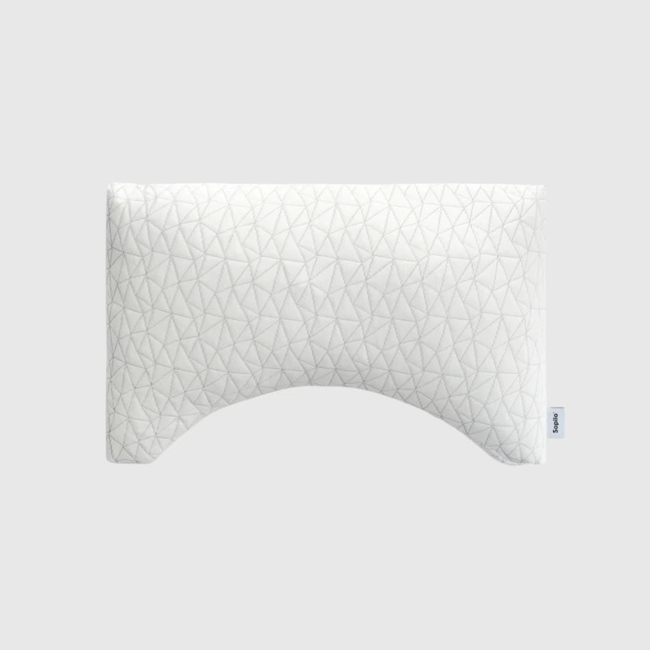White pillow with geometric pattern on a light gray background